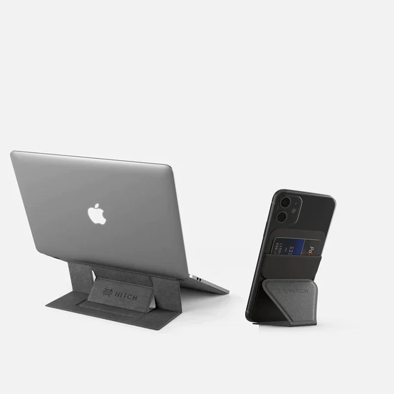 Apple laptop on a "HITCH" invisible stand and a smartphone on a mobile stand on gray background."