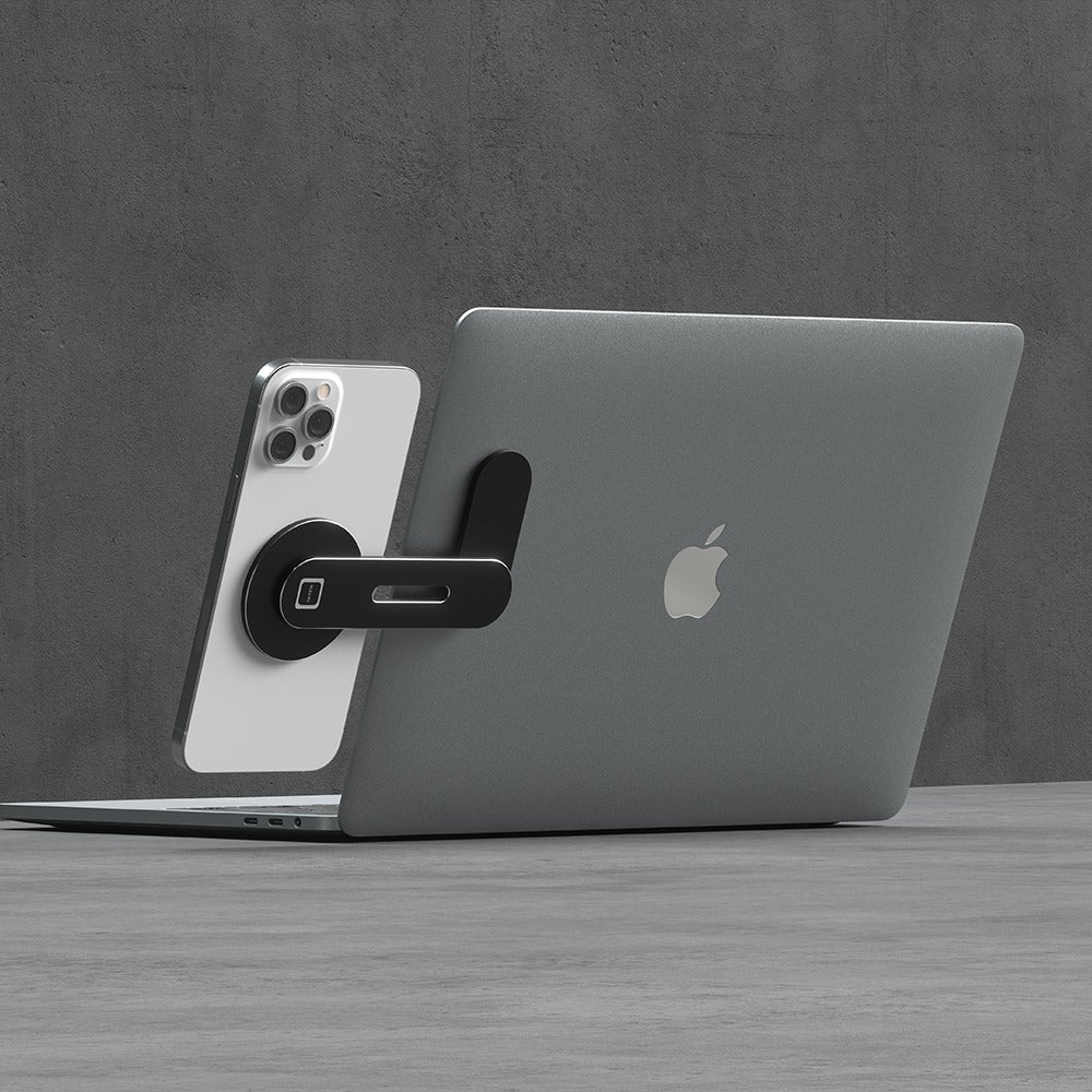 A Phone on a black foldable phone mount, mounted seamlessly on a laptop.