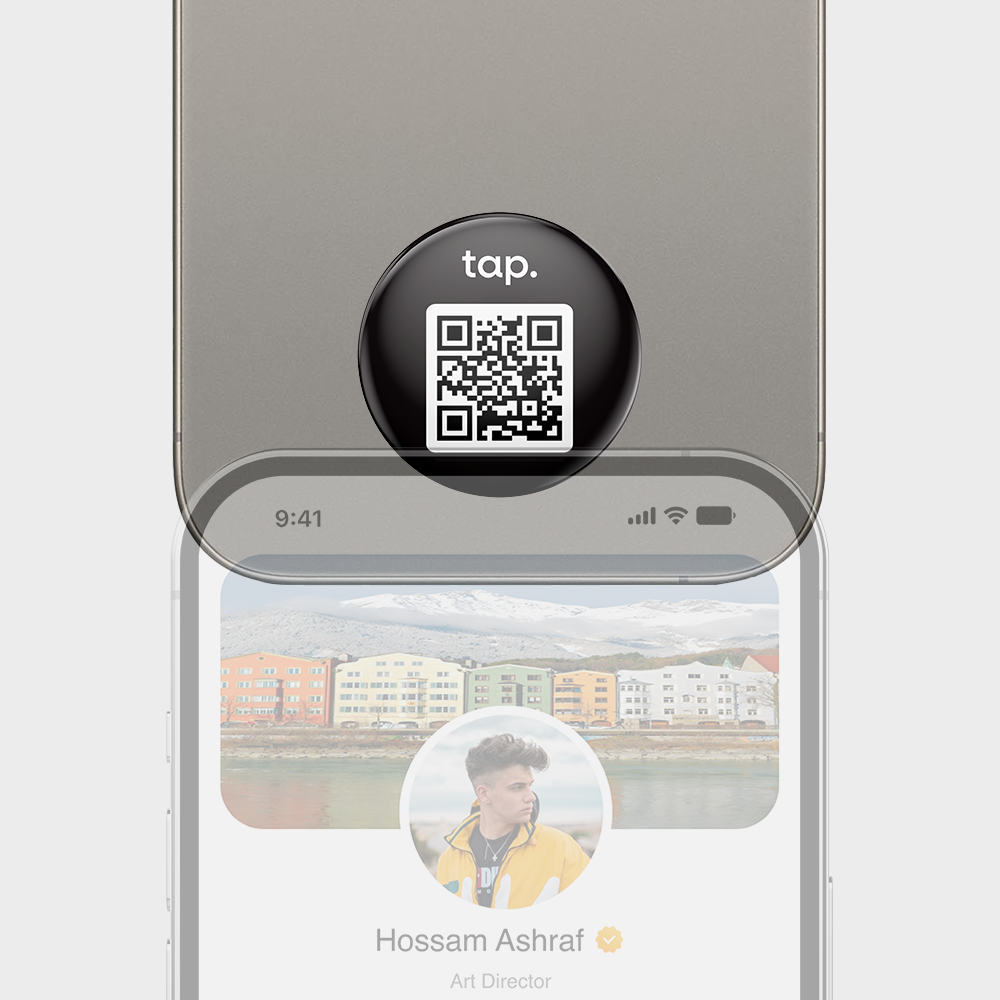 Smartphone with NFC tap prompt and QR code displaying on a hovering black circle.