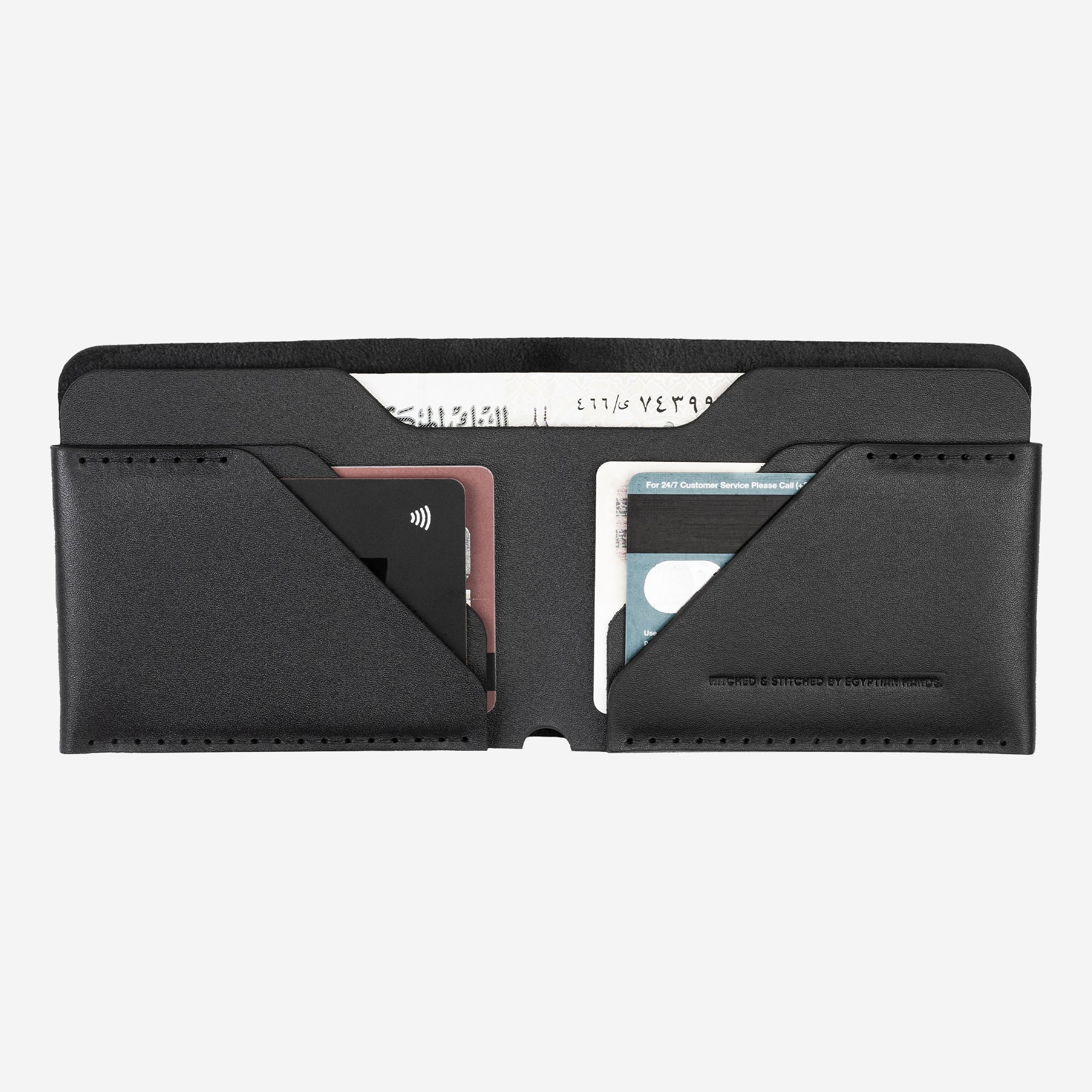 Black leather bifold wallet with credit cards and cash isolated on white background.