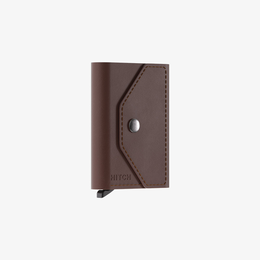 Brown leather wallet with snap closure isolated on white background.