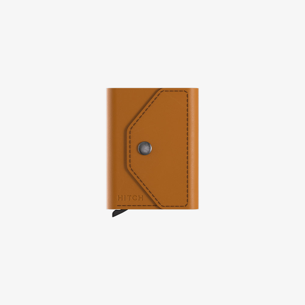 Brown leather wallet with snap closure and embossed "HITCH" logo, isolated on white.