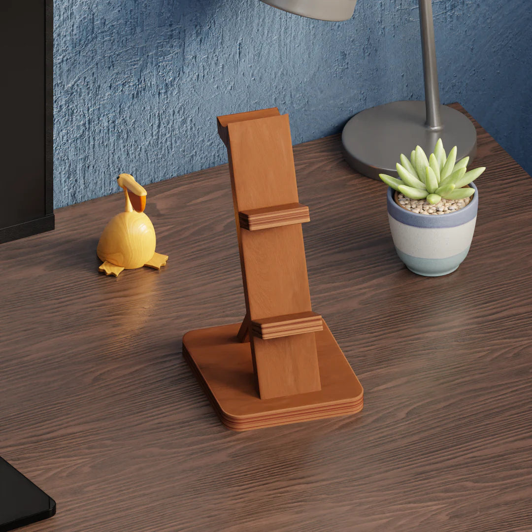 Sleek wooden stand for controllers and headphones on a desk.