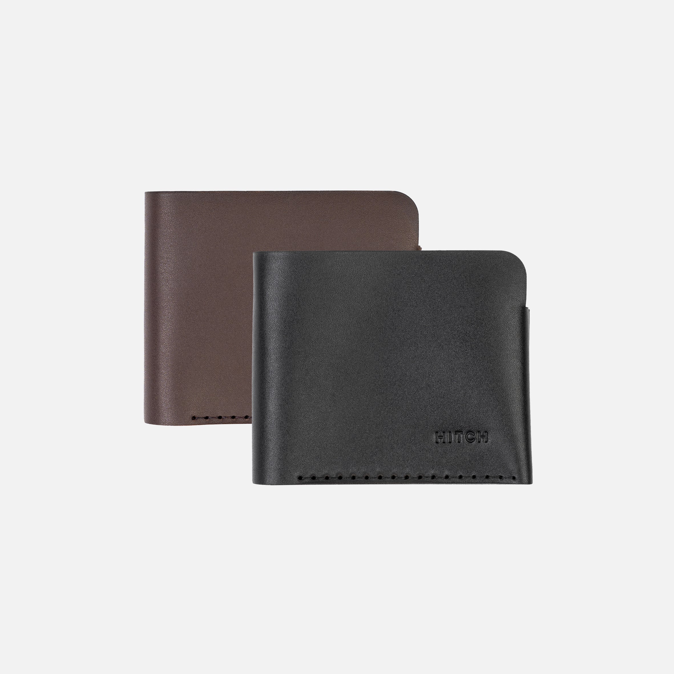 Two leather bifold wallets, one brown and one black, isolated on a white background.
