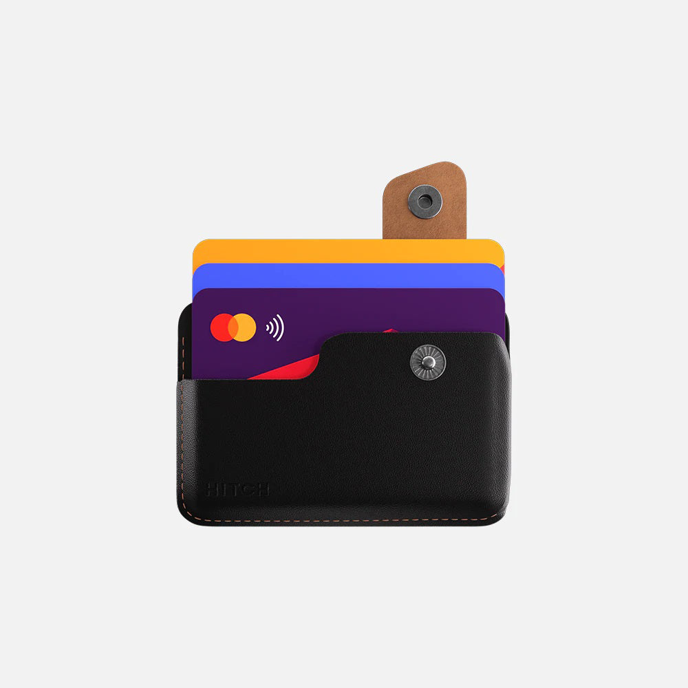 Compact black leather card holder with contactless NFC credit cards on a white background.