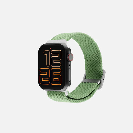 Green braided loop smartwatch with digital display on neutral background."