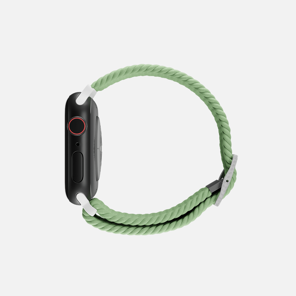Side view green braided solo loop band on smartwatch, isolated on white background.