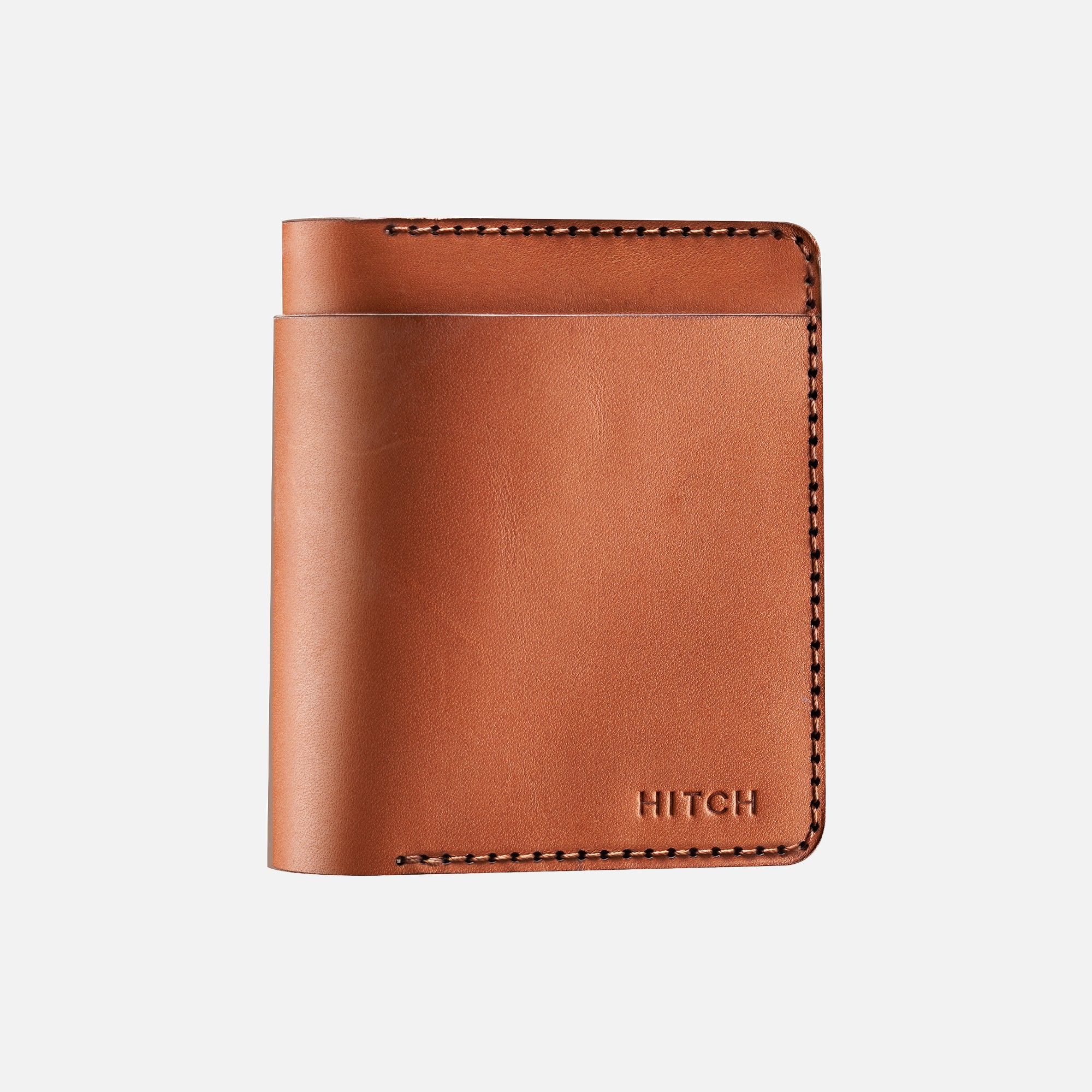 Brown leather bifold wallet with stitching detail and embossed HITCH" logo on a white background.