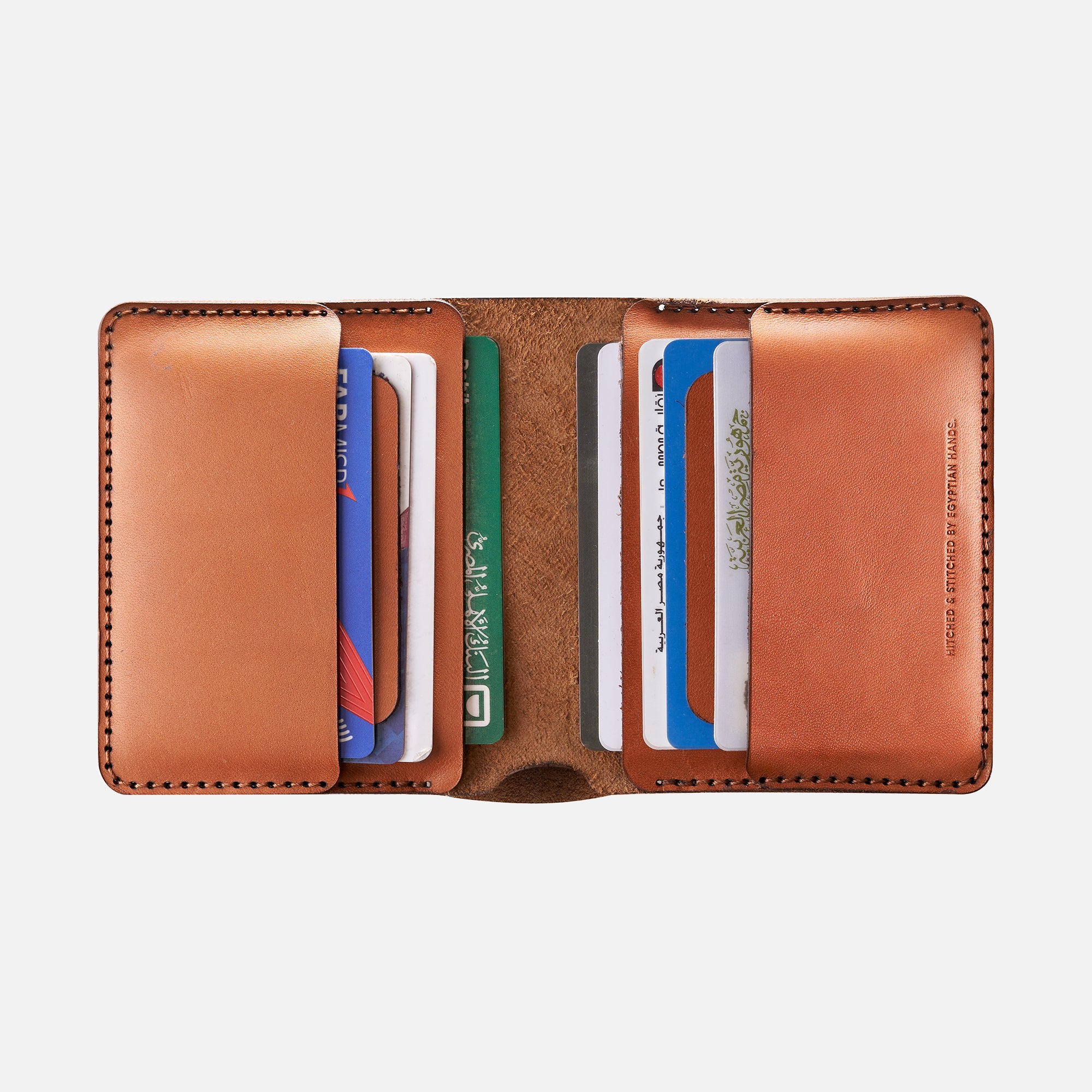 Brown leather bifold wallet with multiple credit cards inside on white background.