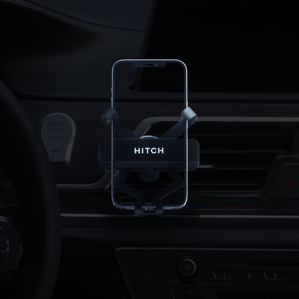 Smartphone mounted on a car holder with HITCH" branding near the vehicle's start-stop engine button.