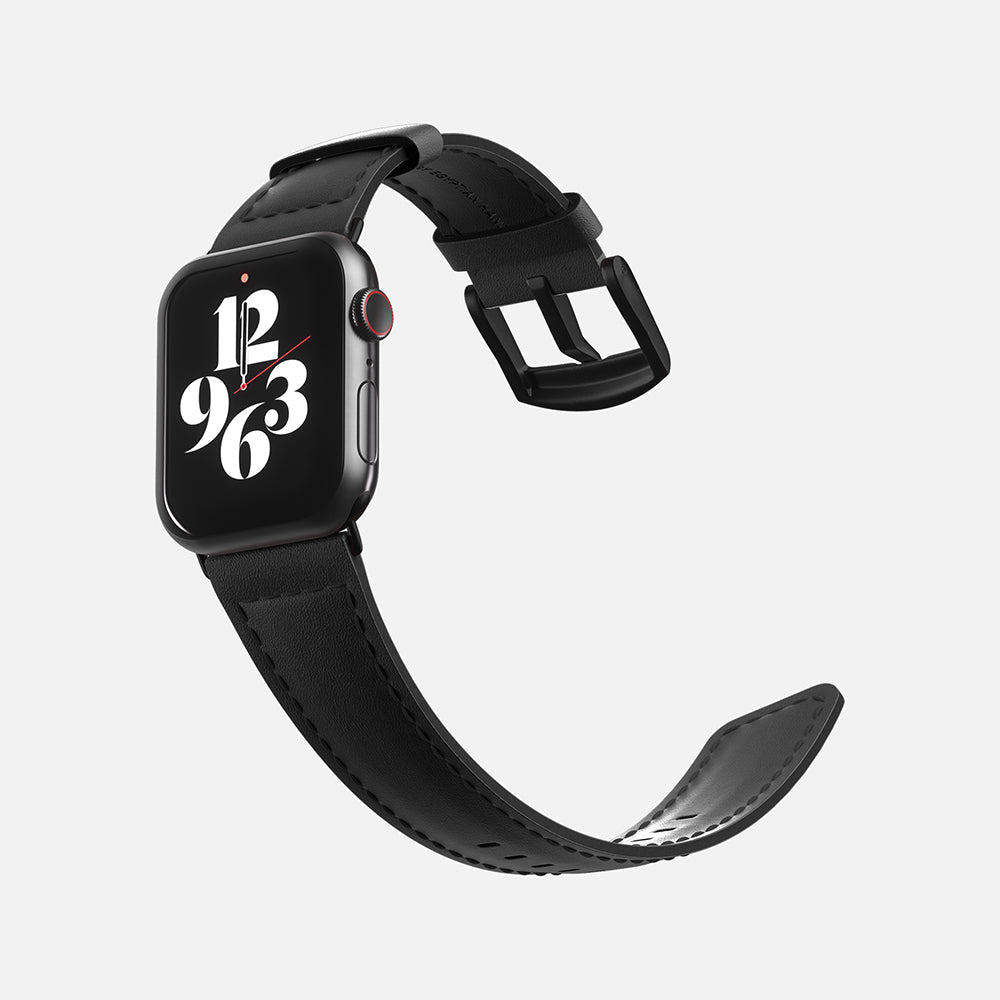 Apple smartwatch with stylish number face and black leather strap on a white background.