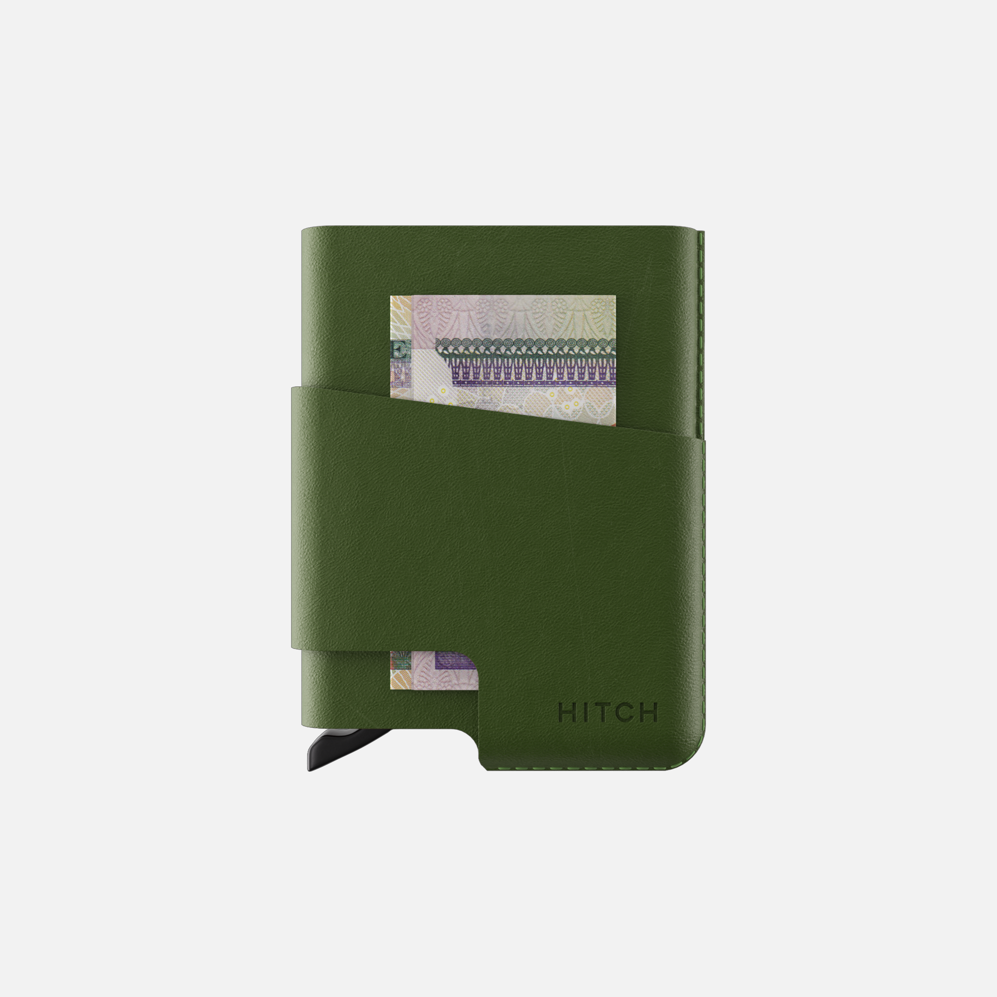 Green leather cardholder wallet with elastic closure and currency note visible in pocket, isolated on white background.