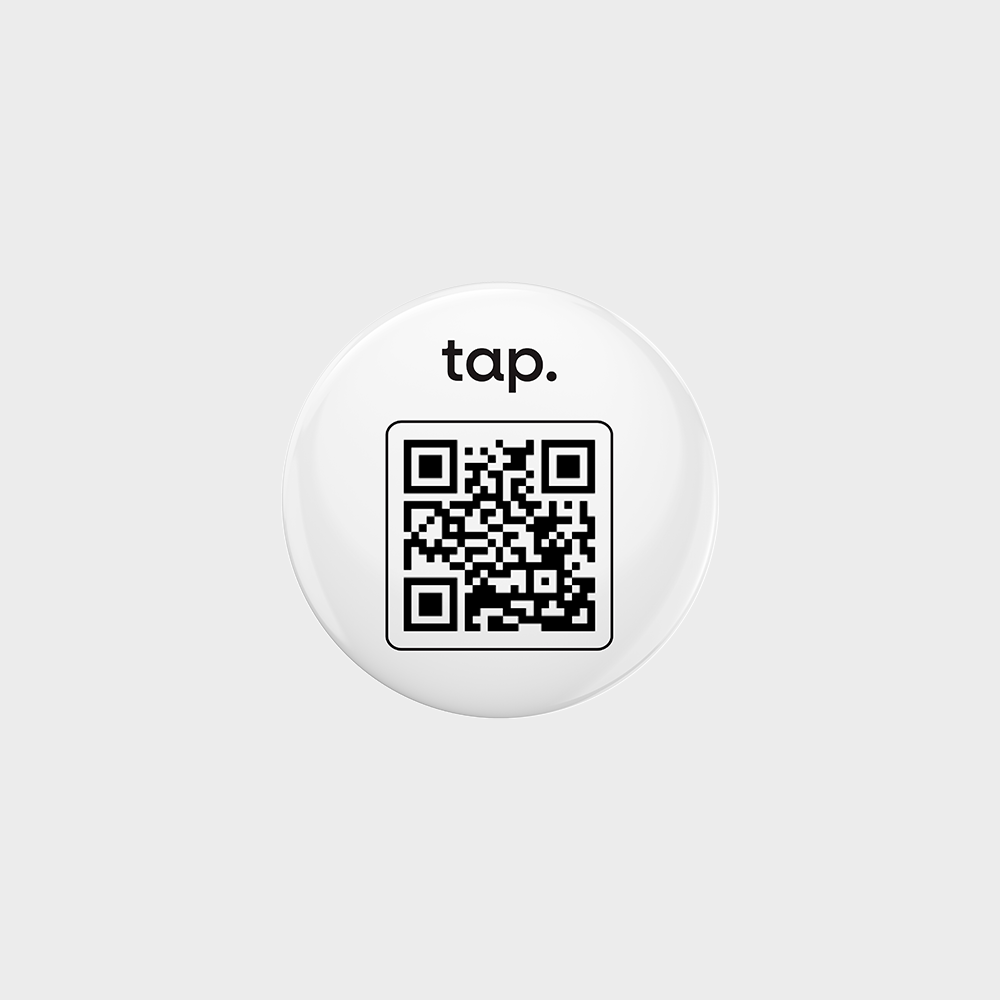 Round white badge with a black QR code for contactless information sharing