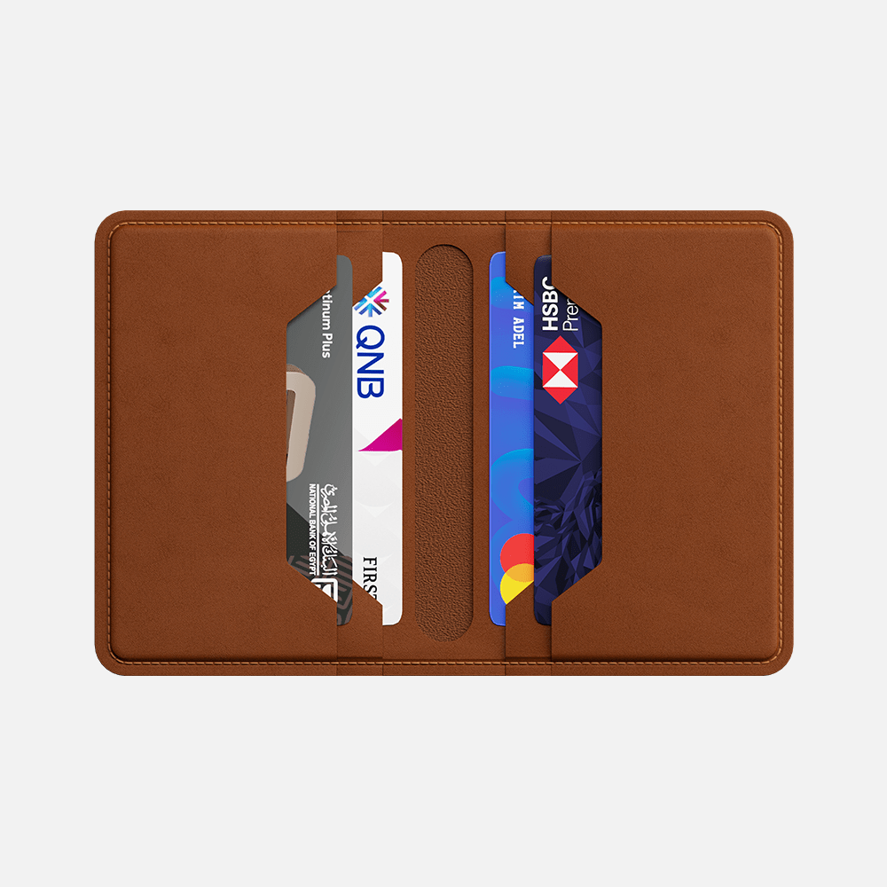 Brown leather bifold wallet with credit card slots containing various cards.