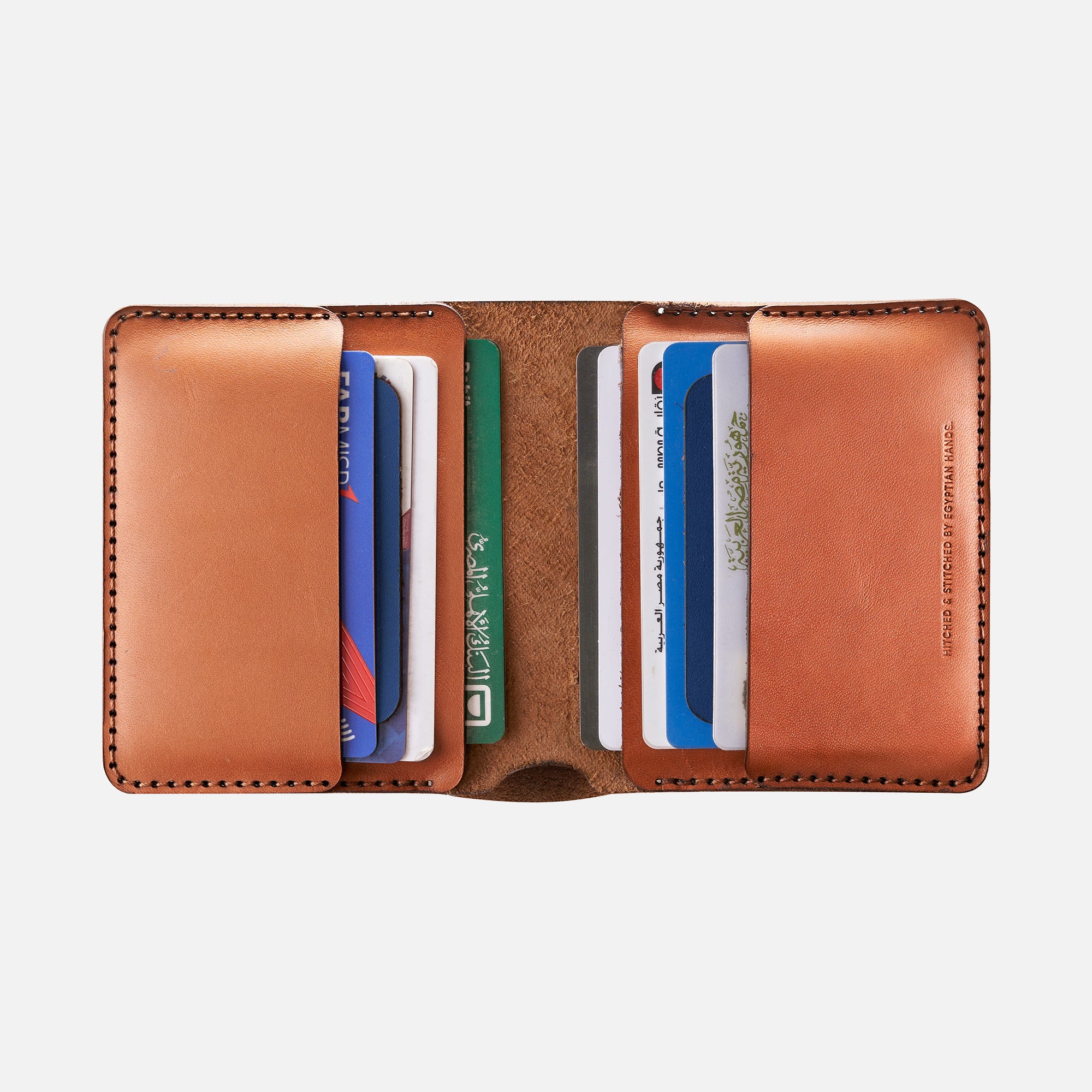 Brown leather bifold wallet with multiple credit cards inside isolated on white background.