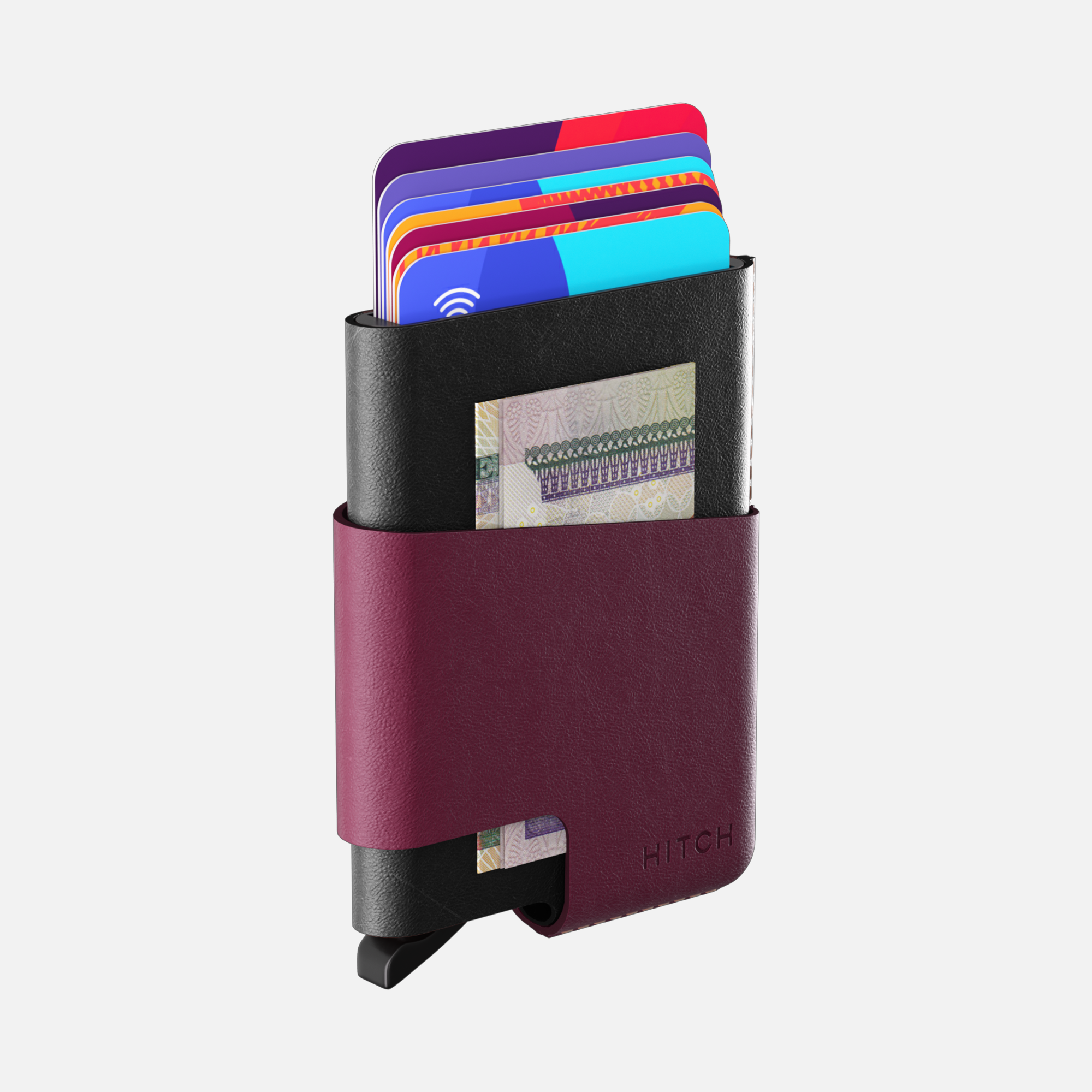 Compact black and maroon leather wallet with colorful credit cards and cash on white background.