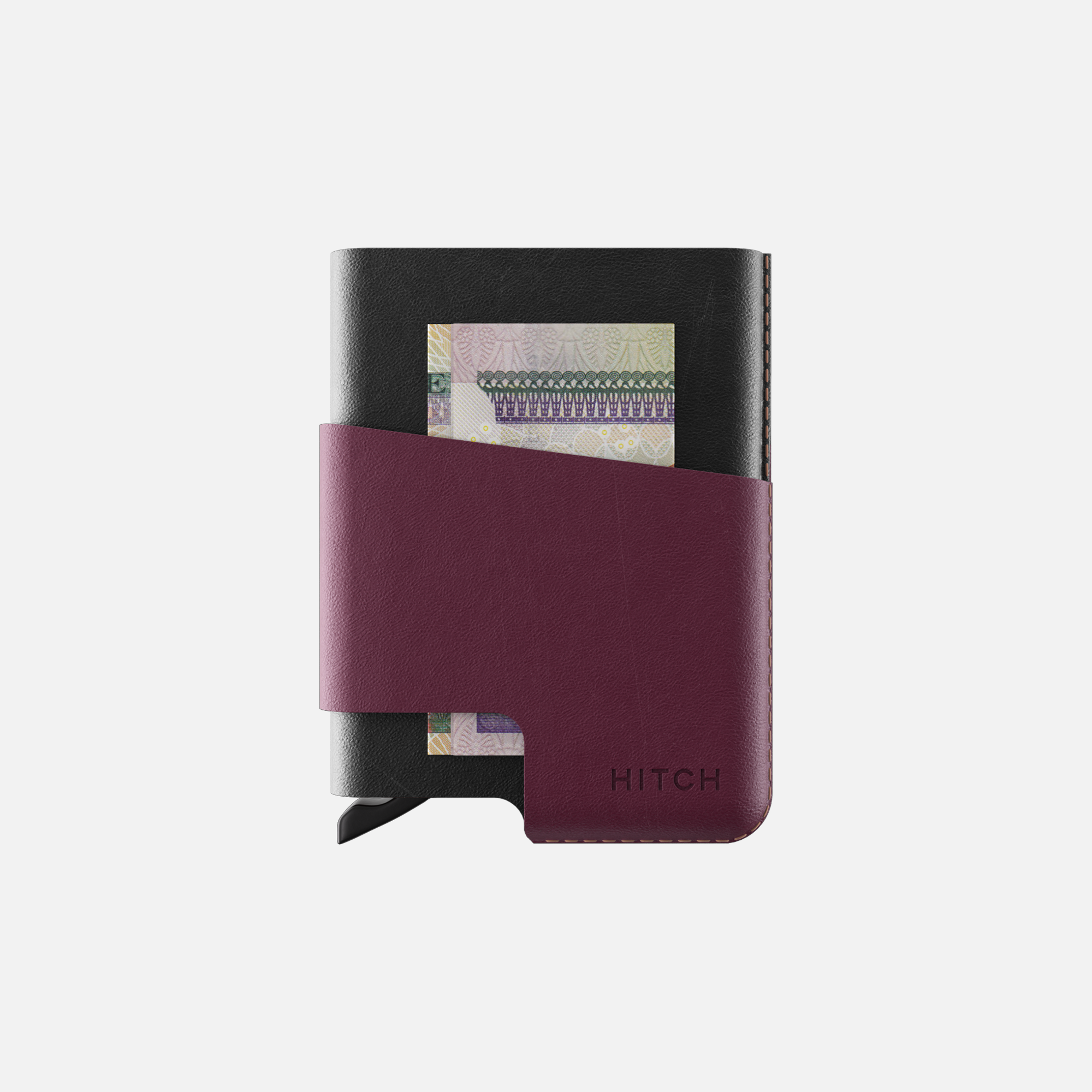 Black and burgundy wallet with money sticking out on a white background