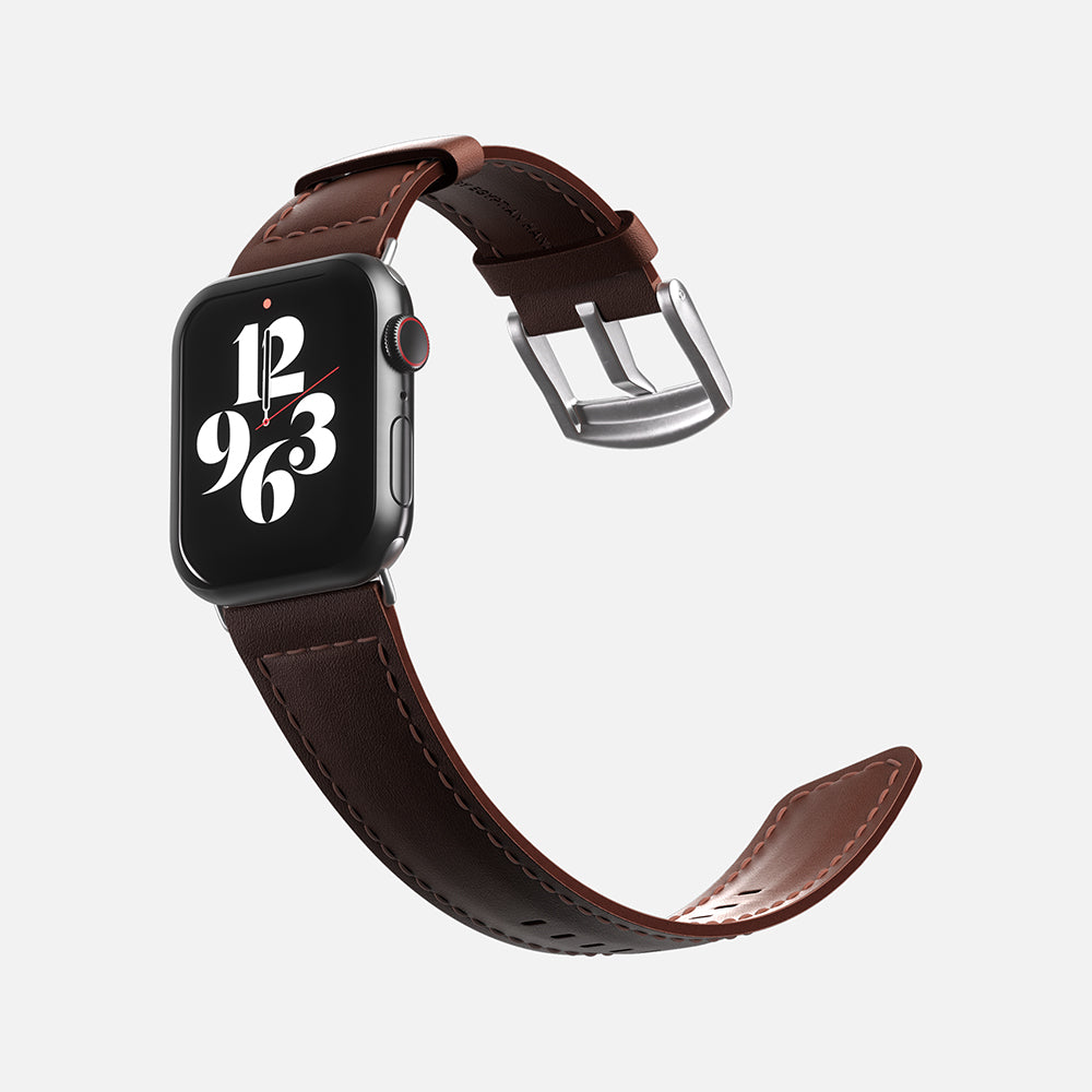 Apple Smartwatch with brown leather strap and digital clock face on a white background.