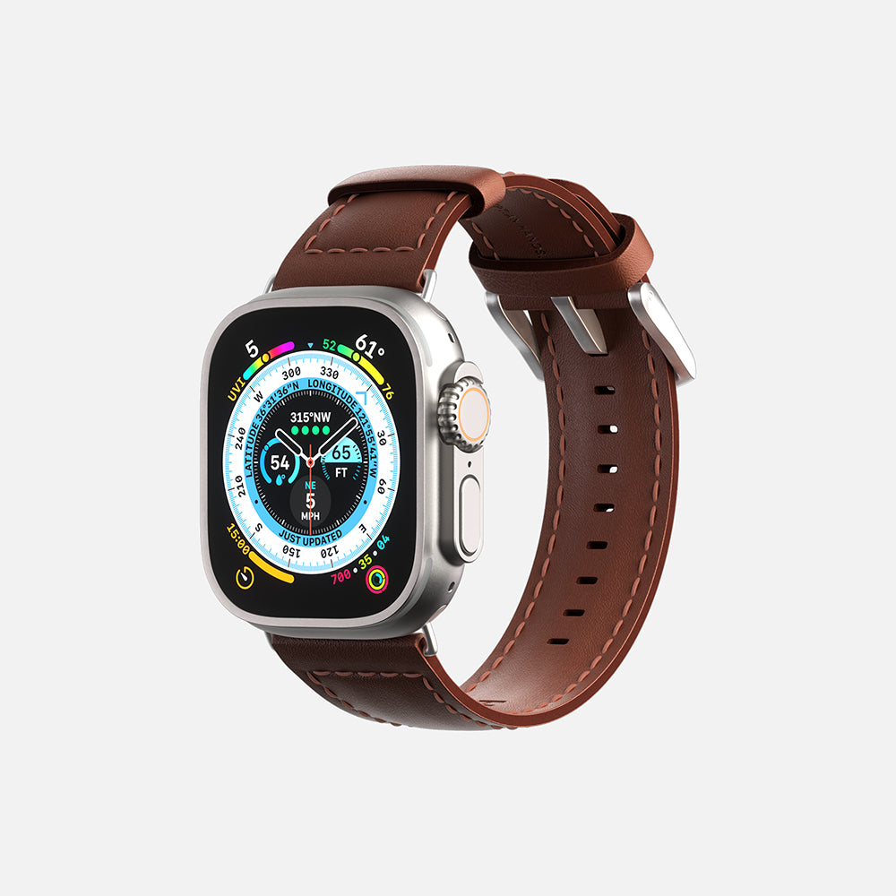 Front view of an Apple Smartwatch with brown leather strap, digital compass face, and silver case on a white background.
