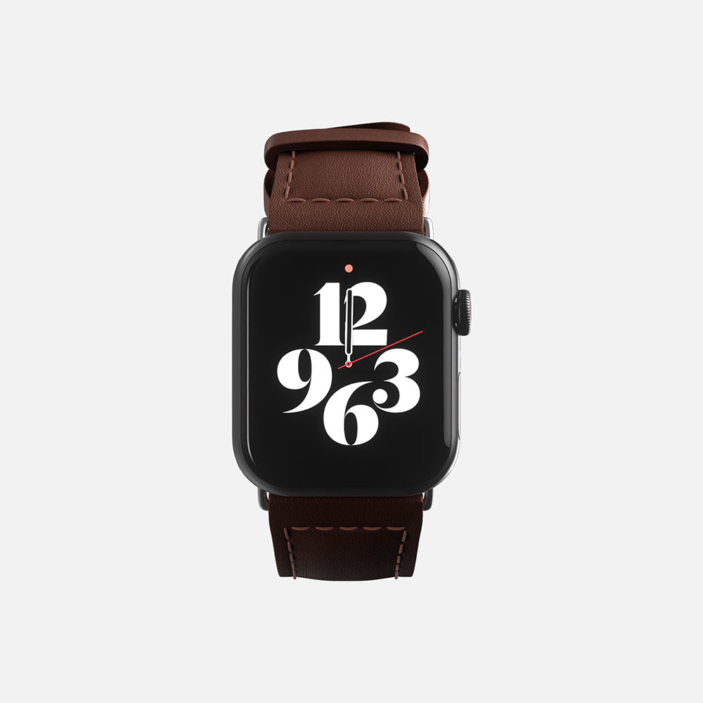 Modern Apple smartwatch with stylish brown leather strap and black face displaying time in unique numeral design.