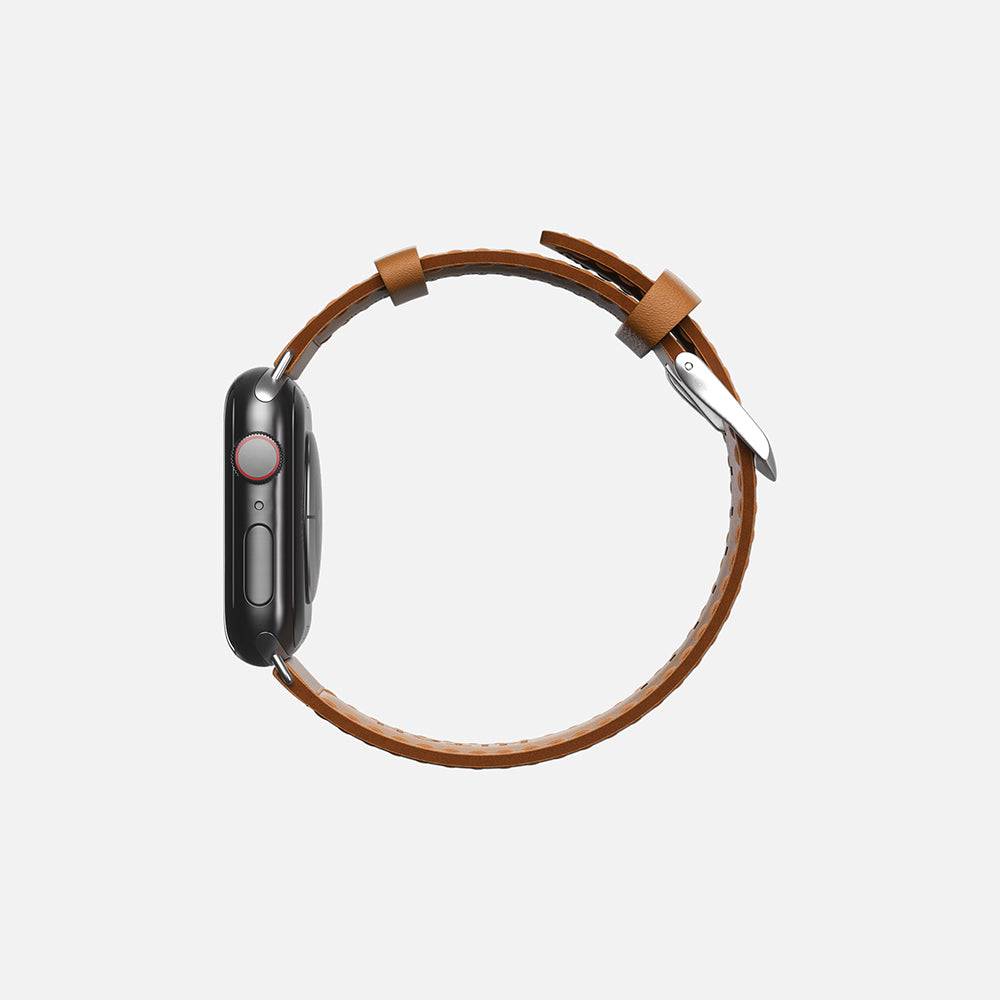Side view of a Brown leather Apple smartwatch with digital crown on white background.