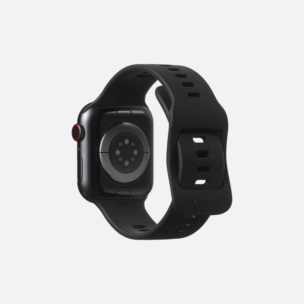 Black smartwatch with red digital crown, sports band, and sensors on back.